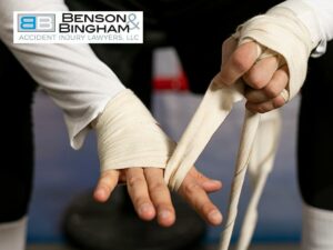 Close-up of a person's hands being wrapped with white bandages, potentially after being hit by falling debris