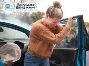 Person clutching head after car accident, emphasizing the importance of medical documentation