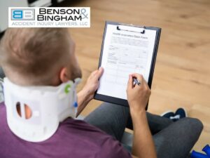 Nevada injury lawyer assisting a client with a neck brace in filling out a health insurance claim form