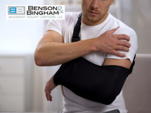 Man with injured arm in a sling