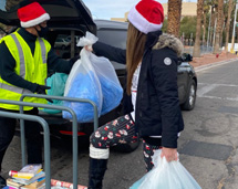 Volunteers Loading Bags On Car For Delivery During Xmas Season