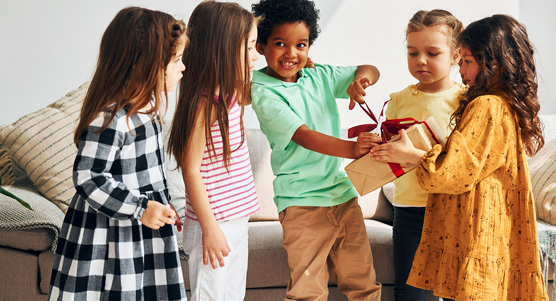 Group Of Kids Opening A Present Box