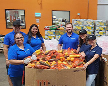 Our Volunteers Next To Big Boxes Of Food Donations