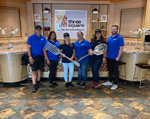 Volunteers Holding Giant Cutlery At Three Square Event