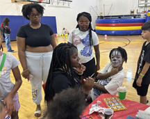 Painting Faces In A School's Gym