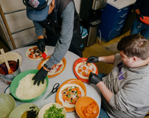 Volunteers Preparing Food For Homeless And At-Risk Youth