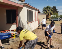 B&B's Group Of Volunteers Working On A Home's Backyard