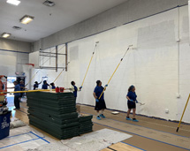 Group Of Volunteers Painting The Inside Of A Building