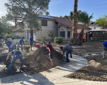 Group Of Volunteers Working On a Front Yard