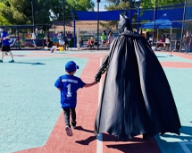 Young Child Holding Hands With Batman