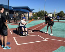 Teenager On Wheelchair About To Bat The Ball