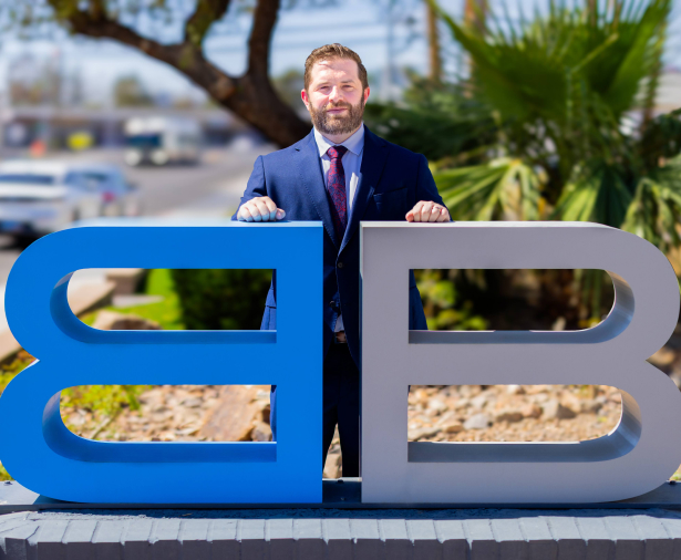 Jordan Kingsley, attorney, standing with the Benson & Bignham logo