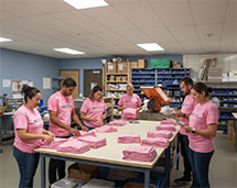 Our Legal Team Volunteering At The Karma Project Organizing Shirts