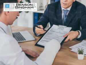 A Truck Crash Victim signing papers with the help of a lawyer